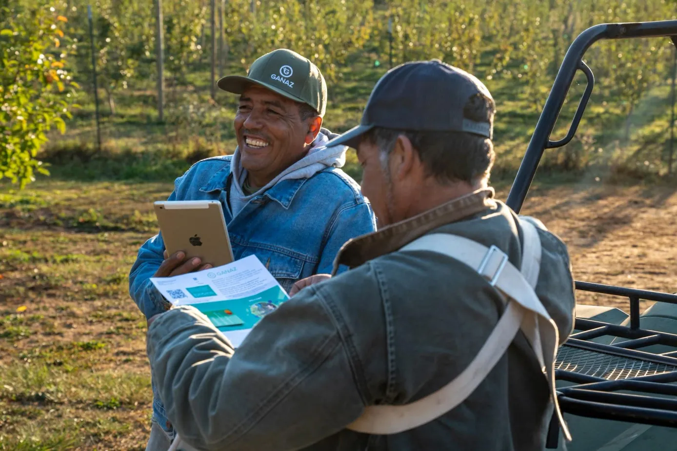 A Ganaz team member helping an agricultural worker complete hiring in the field